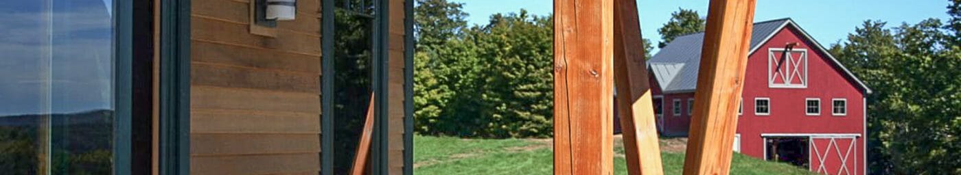 Exterior beams with stone post bases on the porch of the Night Pasture Farm in Chelsea, VT