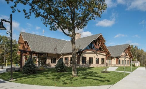 Exterior of the Adirondack Welcome Center in Queensbury, NY featuring Douglas fir Glulam Heavy Timber Trusses with steel plates.