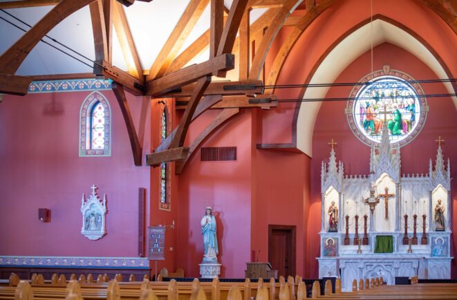 The completed interior of St. Michael's Church with arched trusses and steel tie rods