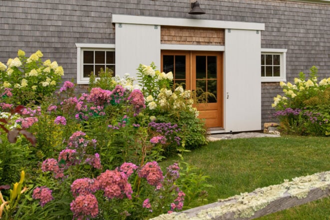 Exterior of a Guest Cottage Beach House in Martha's Vineyard overlooking the pool with traditional weathered Cedar siding